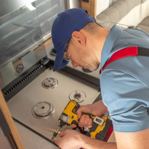 Technician repairing a cooktop for appliance repair in Centreville VA