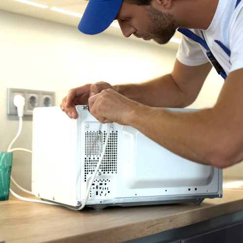 Technician repairing a microwave for appliance repair in Vienna VA