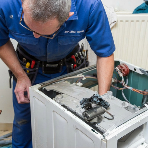 Technician repairing a washing machine for appliance repair in West Falls Church VA